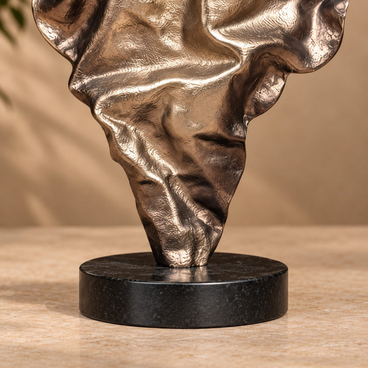 Detailed view of the premium black marble base supporting a handcrafted abstract metal sculpture.