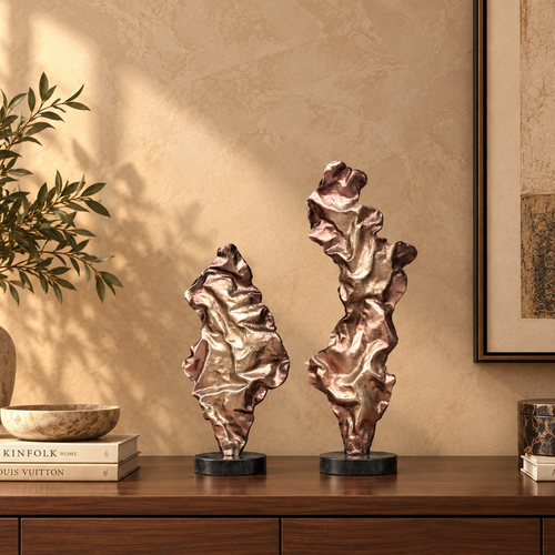 Pair of luxury abstract metal sculptures displayed on a walnut console, creating a sophisticated contemporary home décor setting.