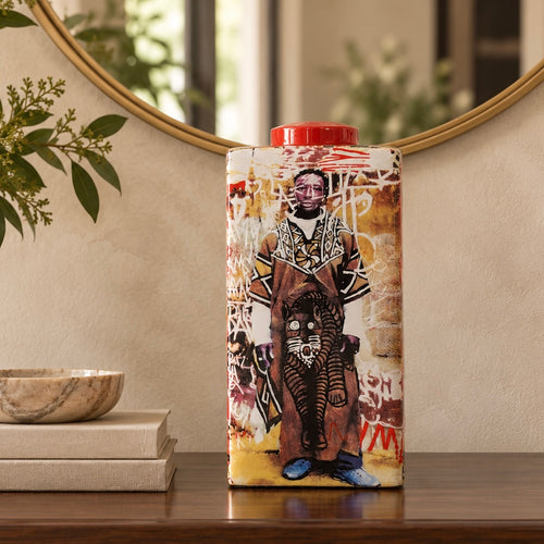 African art ceramic decorative jar with red lid styled on a wooden console in an elegant contemporary interior.