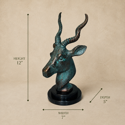 Antelope head sculpture with verdigris patina on a black base showing dimensions: 12 inches height, 7 inches width, and 5 inches depth against a luxury beige studio background.