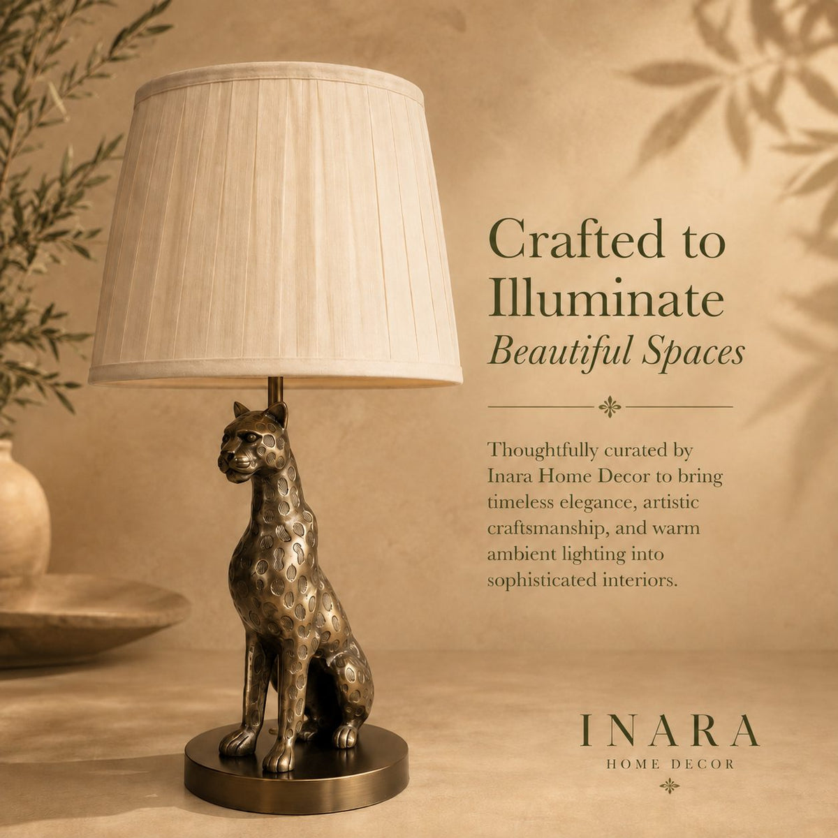 Luxury leopard table lamp with a pleated fabric lampshade in an antique brass finish, showcased on a warm beige editorial background with elegant typography by Inara Home Decor.