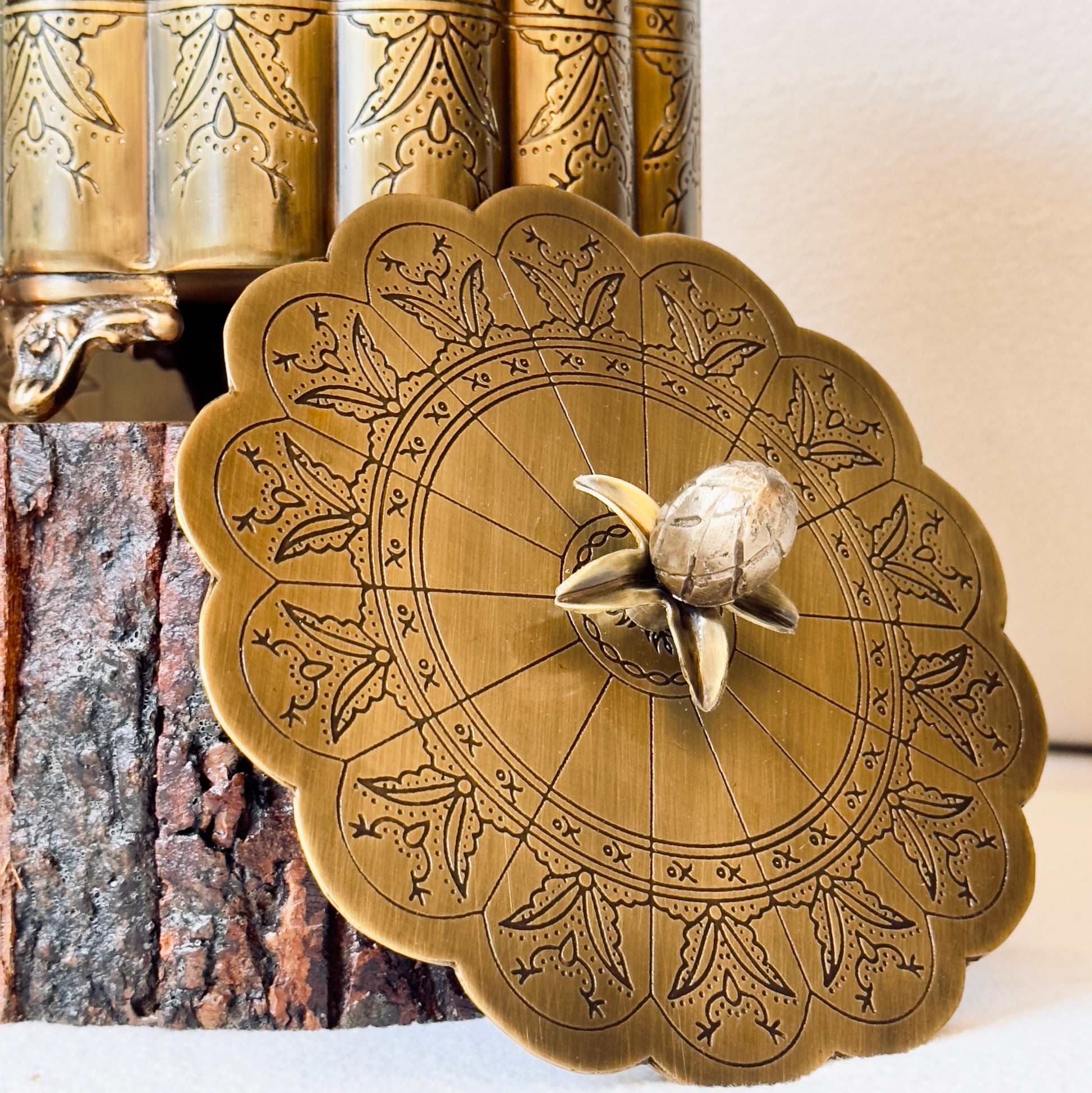 Antique gold brass keepsake box lid with intricate engraved round floral design, decorative brass storage container detail for luxury home décor and gifting