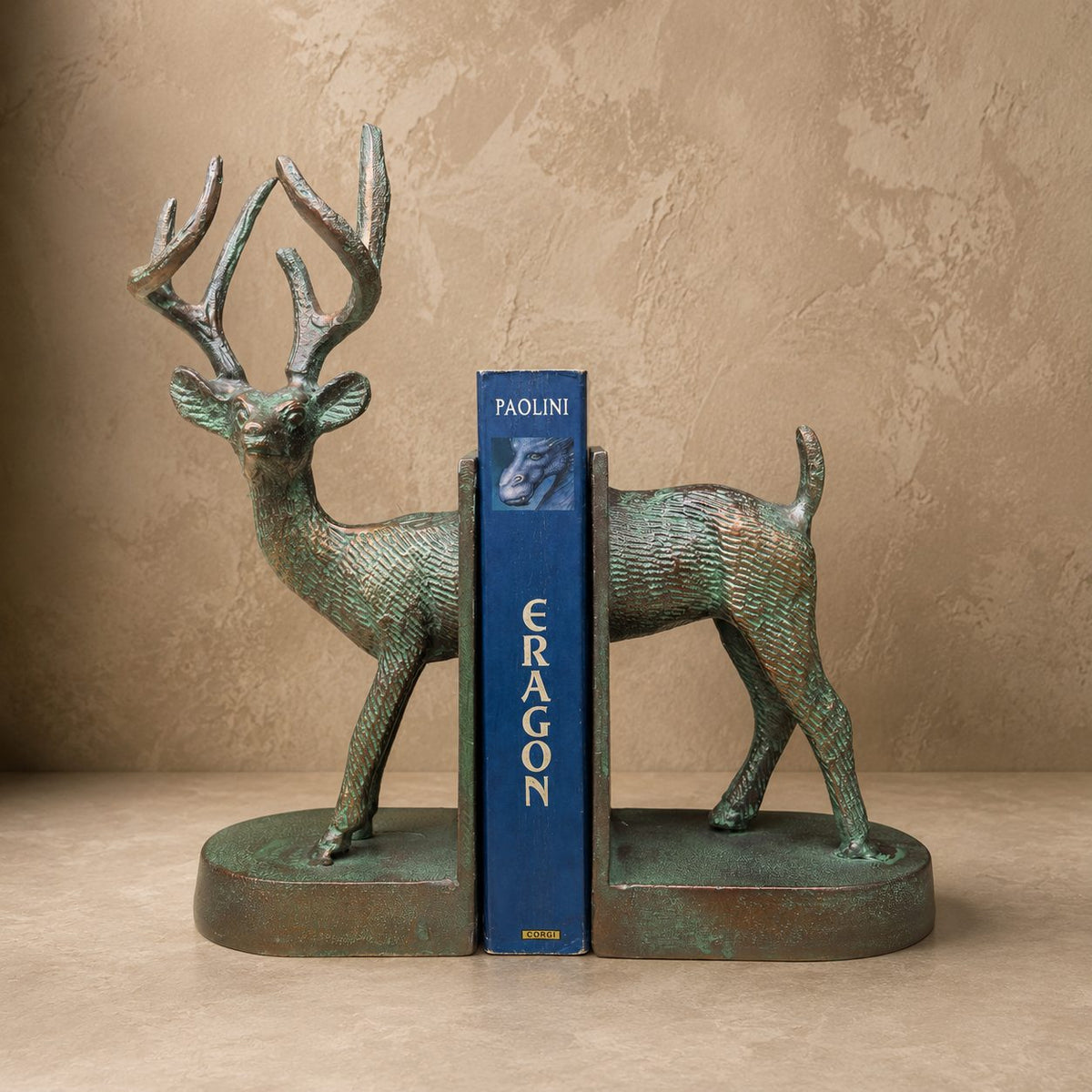 Luxury verdigris deer bookends with a decorative book, handcrafted metal bookends for bookshelves, consoles, home libraries, and premium home décor.