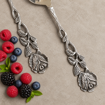 Detailed view of the handcrafted Antique Rose floral metal handles on the cake server and serving fork.