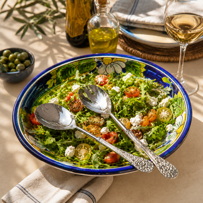 Antique Silver Serving Spoon and Fork Set displayed on a colorful ceramic salad bowl with fresh salad, styled on a warm beige Venetian seamless matte microcement surface for elegant dining and serving.