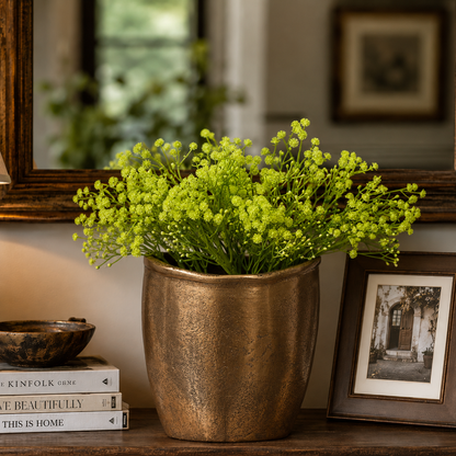 Artificial green Baby Breath stems arranged in a textured brass planter for luxury home décor styling.