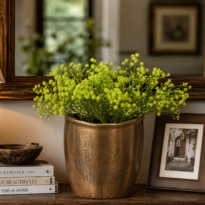 Artificial green Baby Breath stems arranged in a textured brass planter for luxury home décor styling.