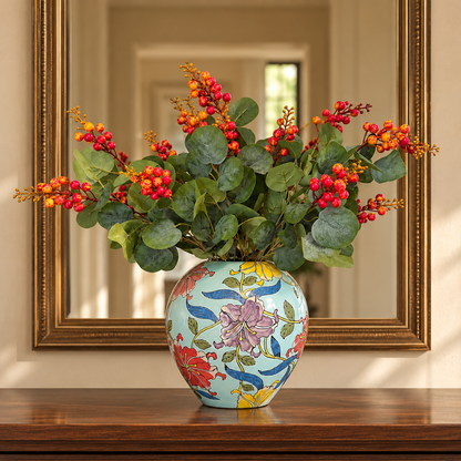 Artificial berry eucalyptus stem arranged in a decorative floral vase for elegant living room and home décor styling.