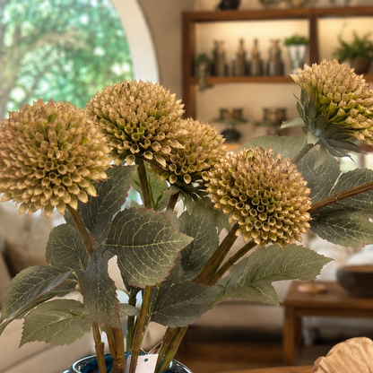 Close-up of realistic artificial cream allium flower stems with lifelike textured blooms and detailed green foliage.