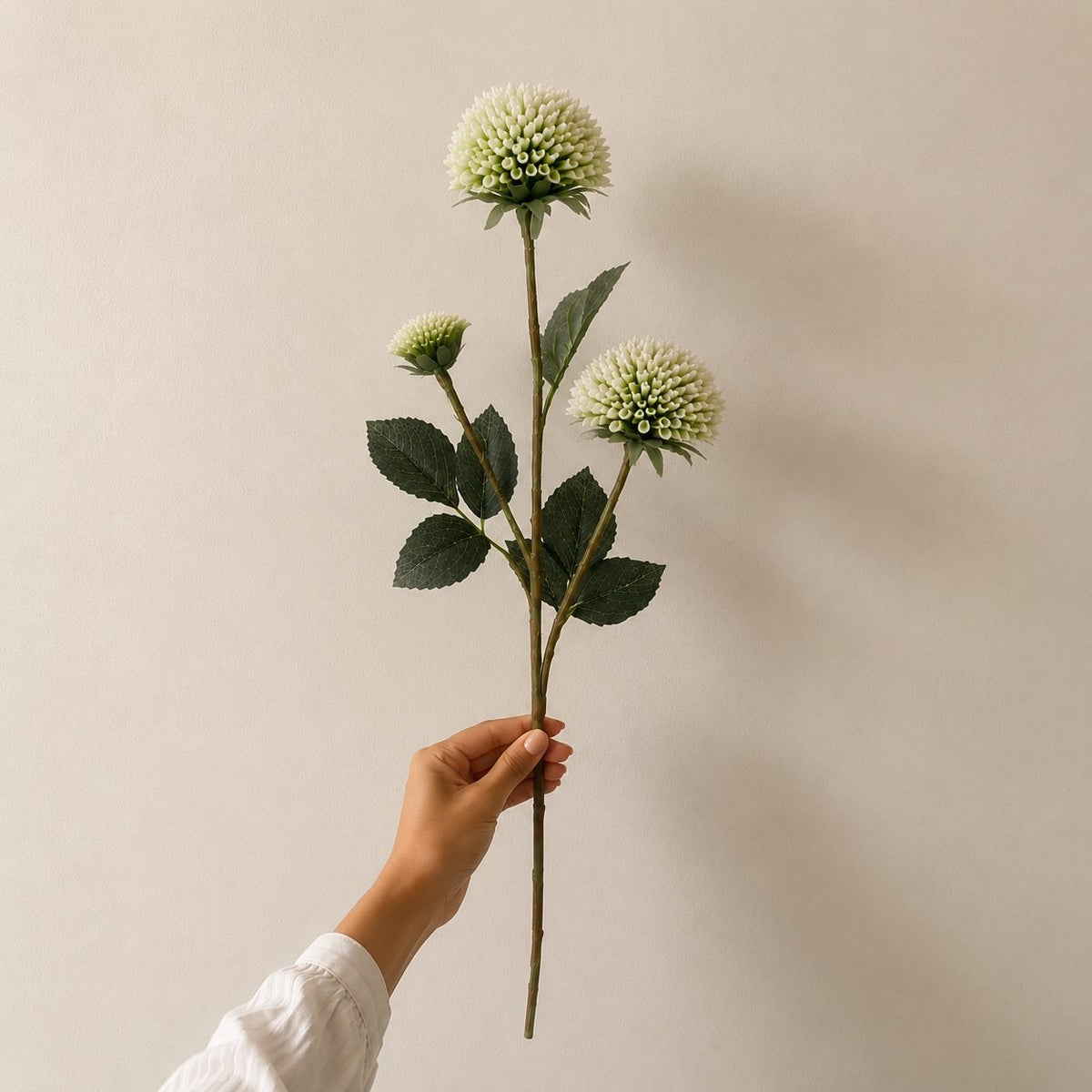 Single artificial white dahlia stem with realistic layered bloom and lifelike green foliage, ideal for premium floral arrangements and home décor.