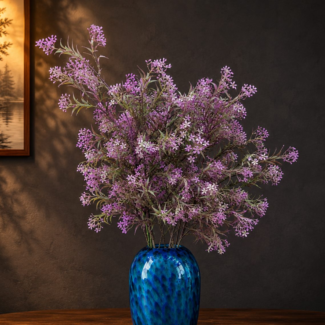Artificial Flower Asparagus Stem Lavender arranged in a blue glass vase, adding soft lavender blooms and elegant charm to a luxury home décor setting.