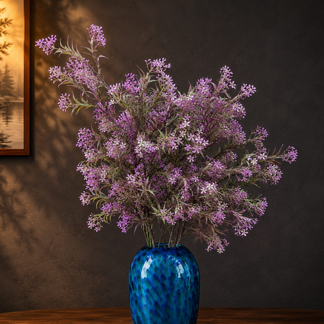 Artificial Flower Asparagus Stem Lavender arranged in a blue glass vase, adding soft lavender blooms and elegant charm to a luxury home décor setting.