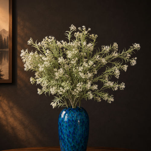 Artificial Flower Asparagus Stems Off White arranged in a blue glass vase, creating a timeless and elegant floral display for modern home interiors.