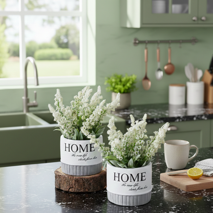 Artificial white flowering plants in ceramic pots placed on a kitchen countertop, adding fresh botanical charm without maintenance.