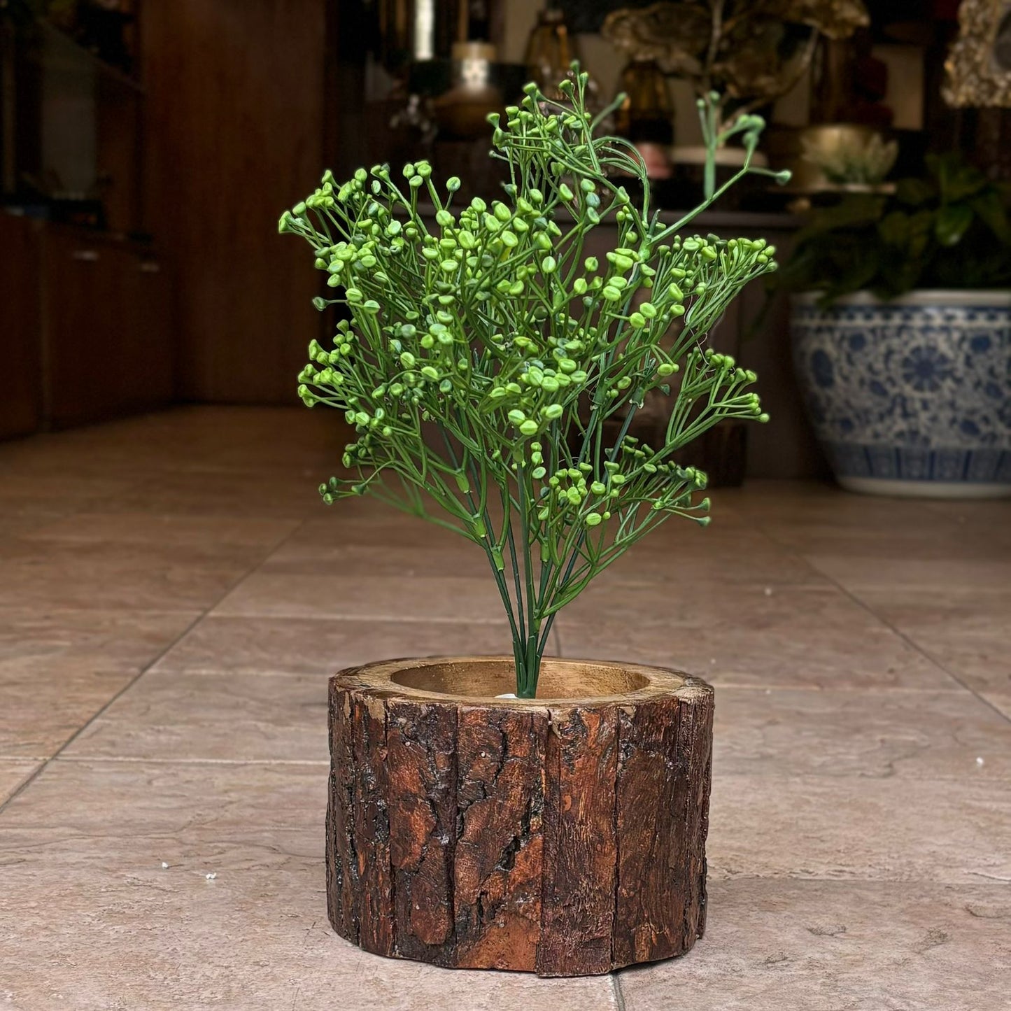 Artificial green baby's breath stem displayed in a rustic wooden planter, adding natural-looking greenery to home décor.