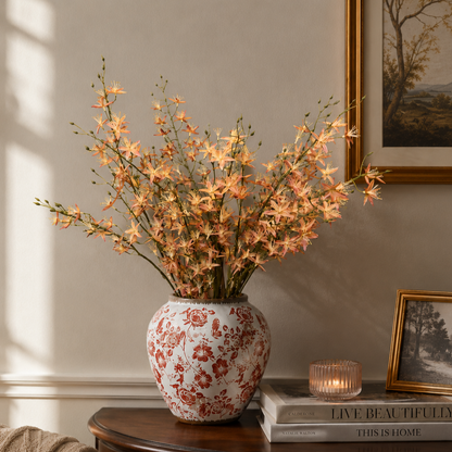 Artificial peach wildflower stems arranged in a decorative ceramic vase, creating a sophisticated luxury home décor display.