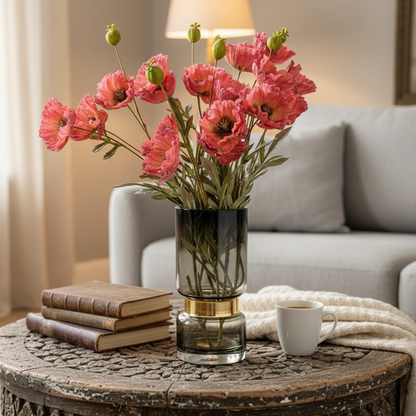 Artificial Poppy Red stems displayed in a glass vase on a coffee table in a modern living room.