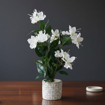Artificial white cherry blossom potted plant in a decorative white ceramic pot for modern home décor.