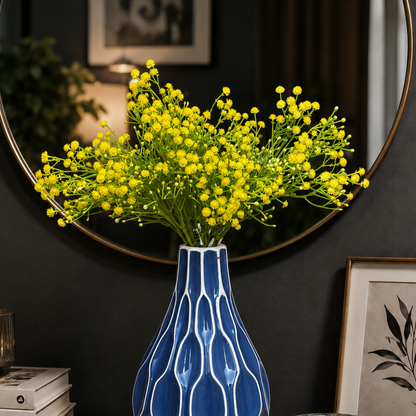 Artificial Yellow Baby's Breath stems arranged in a blue ceramic vase, adding vibrant floral elegance to modern home décor.