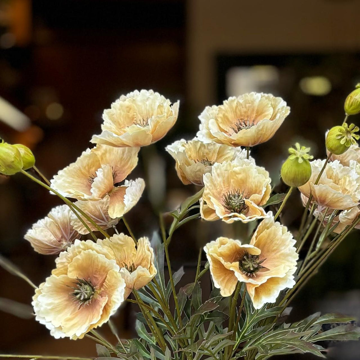 Close-up of realistic artificial yellow poppy flowers with lifelike petals and buds made from premium PU and silk.