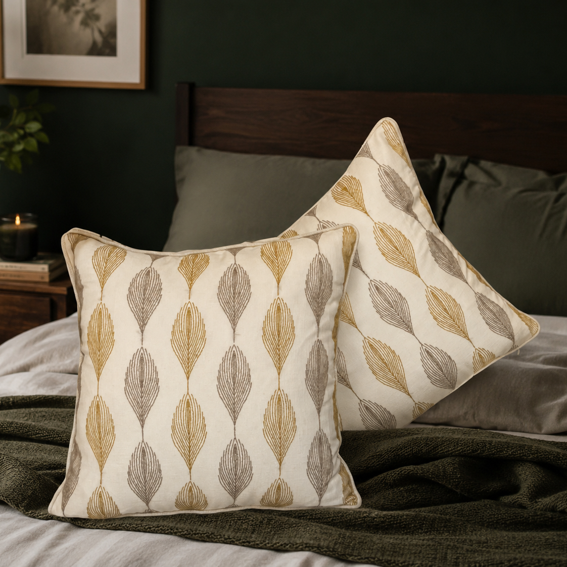 Leaf pattern linen cushion cover styled on a bed in a dark green bedroom with soft neutral bedding and natural light, adding elegant comfort and modern luxury to the space.