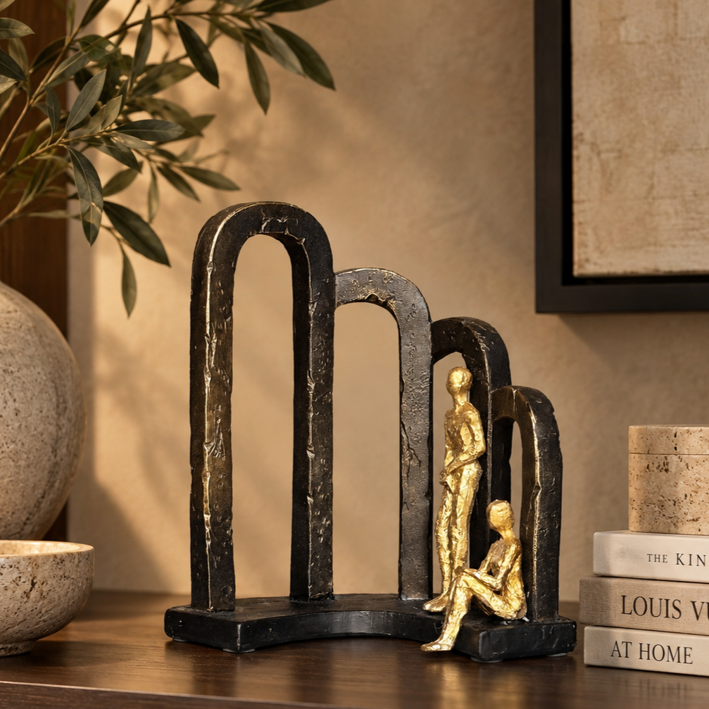Black and gold abstract Togetherness resin sculpture displayed with designer books and modern décor for premium home styling.