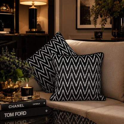 Black and white zig zag velvet cushion covers styled on a luxury beige sofa in an elegant living room with premium décor accents by Inara Home Decor.
