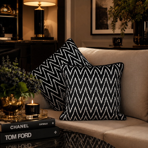 Black and white zig zag velvet cushion covers styled on a luxury beige sofa in an elegant living room with premium décor accents by Inara Home Decor.