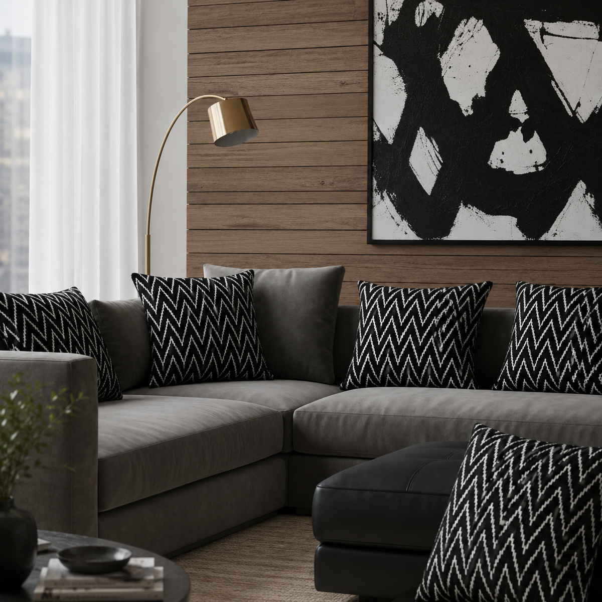 Black Zig Zag Velvet Cushion Covers styled on a modern grey sectional sofa in a contemporary living room with wood panel walls and abstract artwork, showcasing the textured woven pattern and luxury home décor appeal.