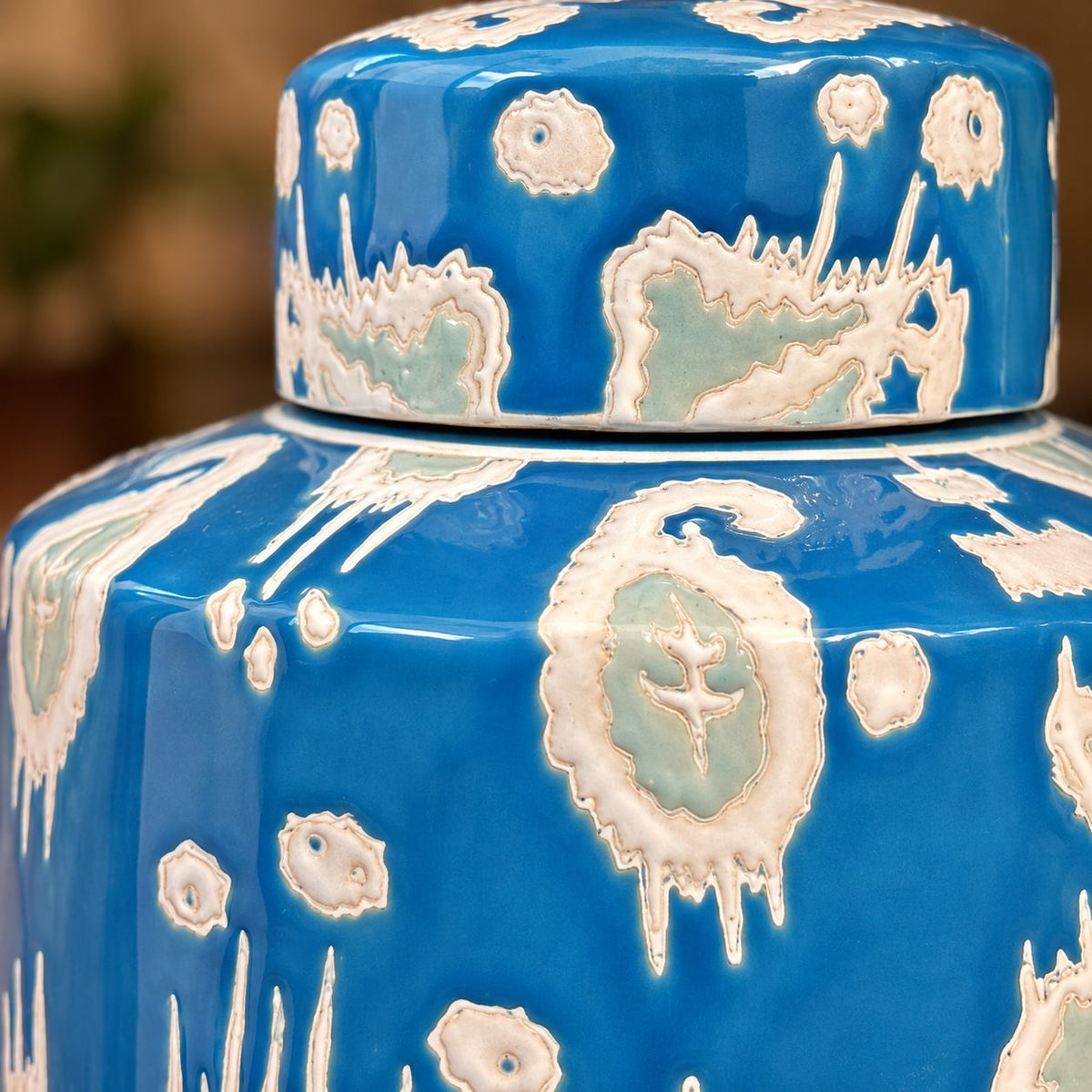 Close-up of handcrafted blue glazed ceramic decorative jar showcasing premium artisan detailing and textured finish.