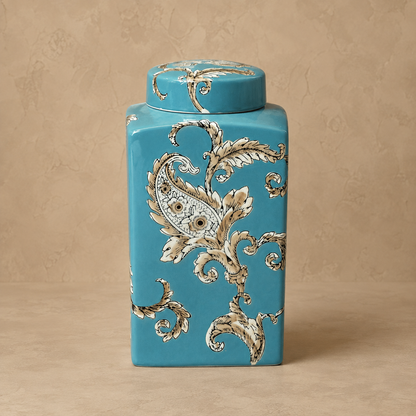 Blue hand-painted ceramic decorative jar with glossy finish featuring elegant floral paisley artwork for luxury home décor.