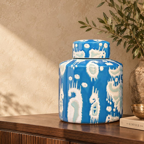 Luxury handcrafted blue ceramic decorative jar styled on a walnut console table in a premium contemporary living space.