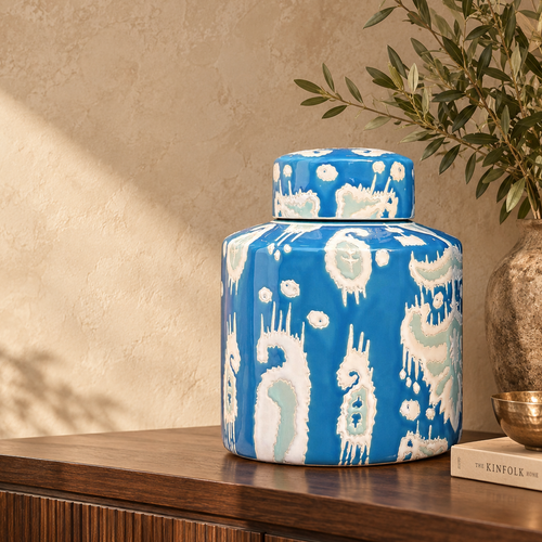 Luxury handcrafted blue ceramic decorative jar styled on a walnut console table in a premium contemporary living space.