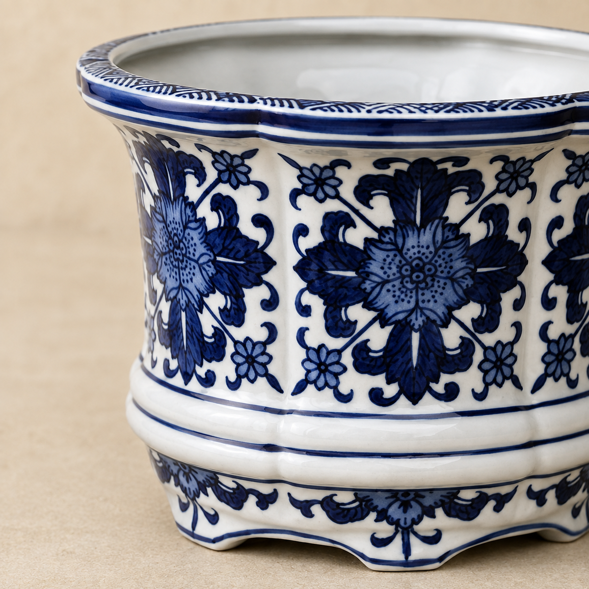 Close-up of a premium blue and white hand-painted porcelain planter showcasing intricate floral artwork, glossy finish, and artisan craftsmanship.