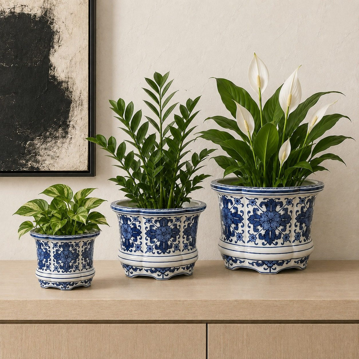 Decorative blue and white porcelain planters styled with indoor plants including Pothos, ZZ Plant, and Peace Lily for a timeless luxury home décor setting.