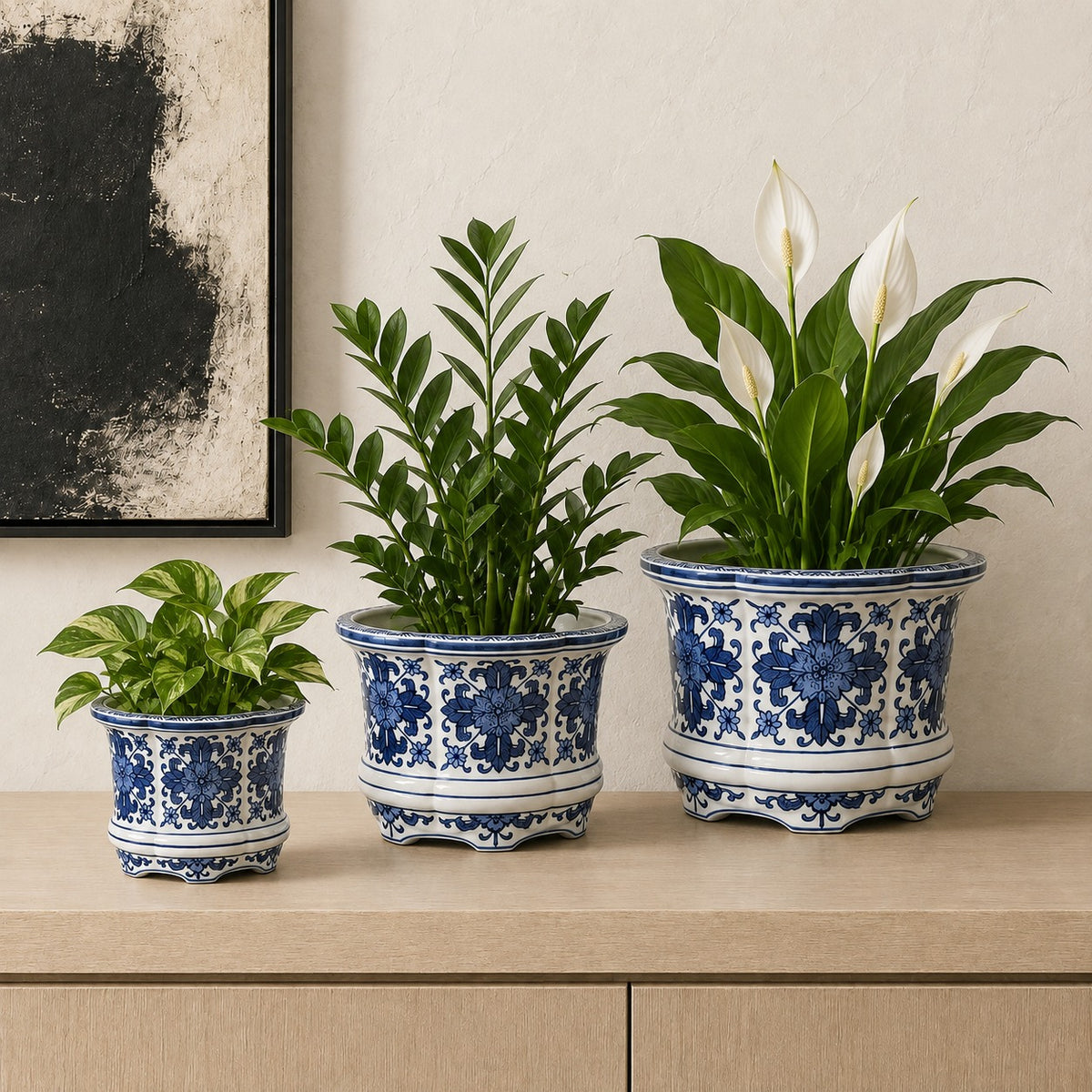 Decorative blue and white porcelain planters styled with indoor plants including Pothos, ZZ Plant, and Peace Lily for a timeless luxury home décor setting.