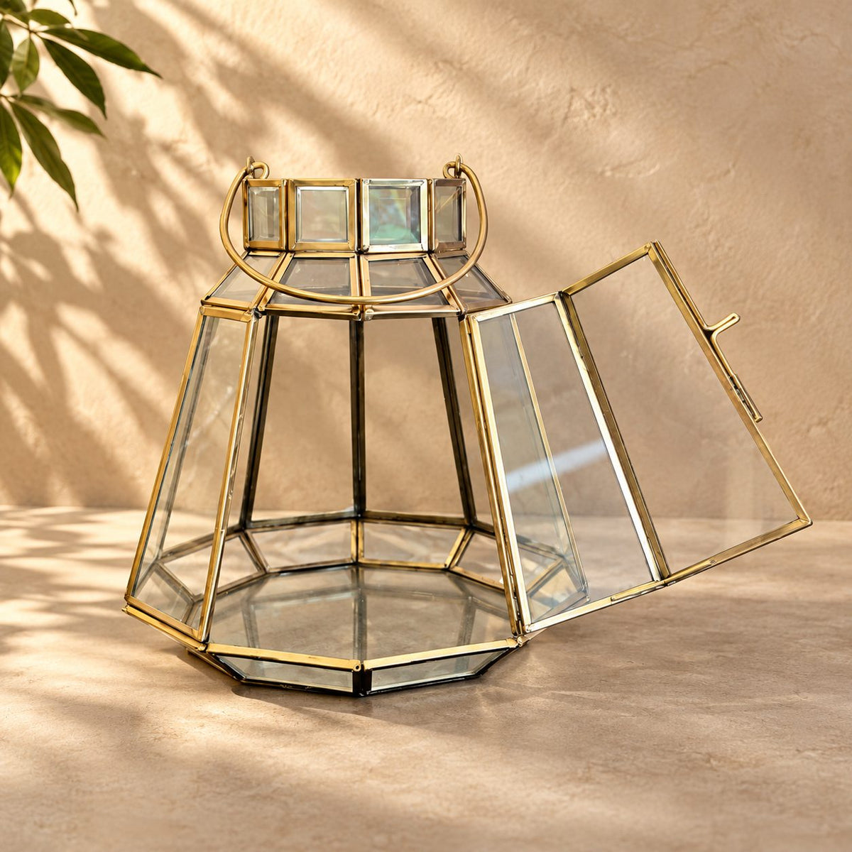 Handcrafted brass and clear glass decorative lantern with its front opening door displayed open, highlighting the spacious interior and premium craftsmanship.