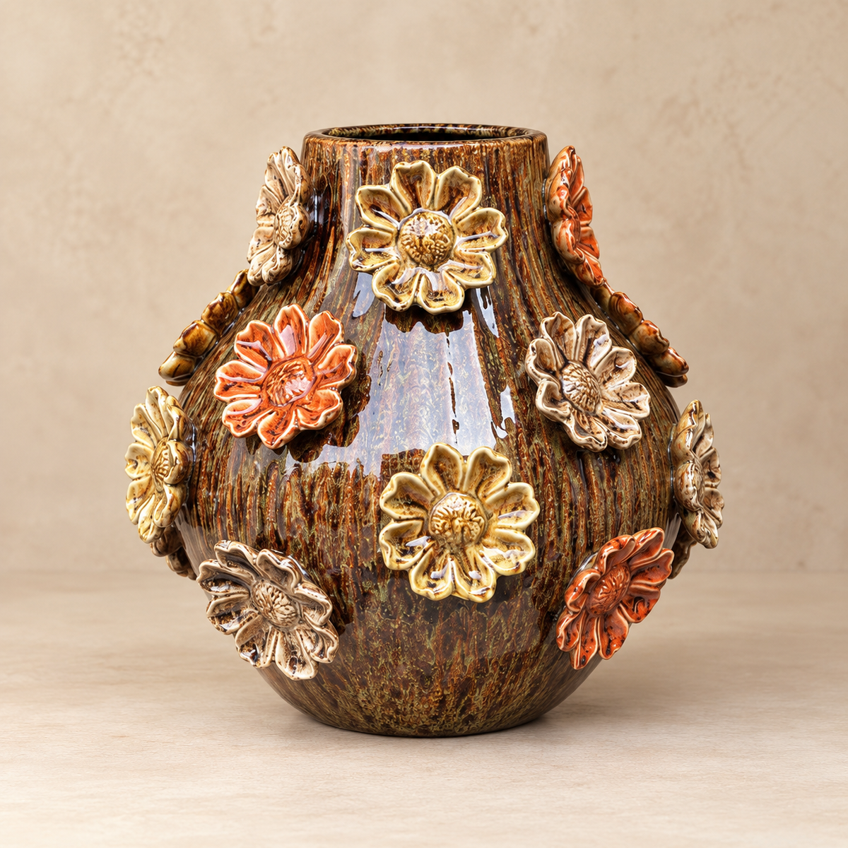 Tall brown glazed ceramic vase with handcrafted raised orange, gold and cream floral embellishments.