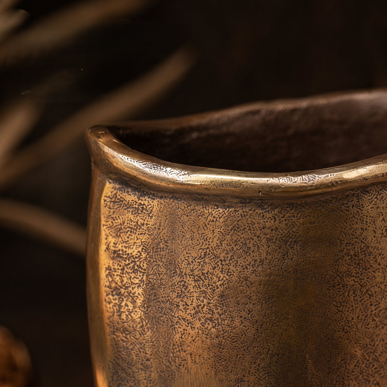Close-up of the handcrafted antique bronze metal vase showcasing its textured finish and artisan craftsmanship.
