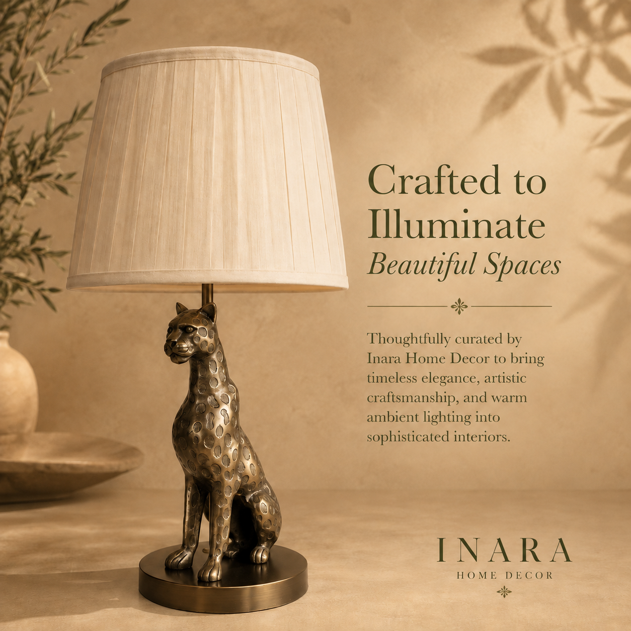 Luxury leopard table lamp with a pleated fabric lampshade in an antique brass finish, showcased on a warm beige editorial background with elegant typography by Inara Home Decor.
