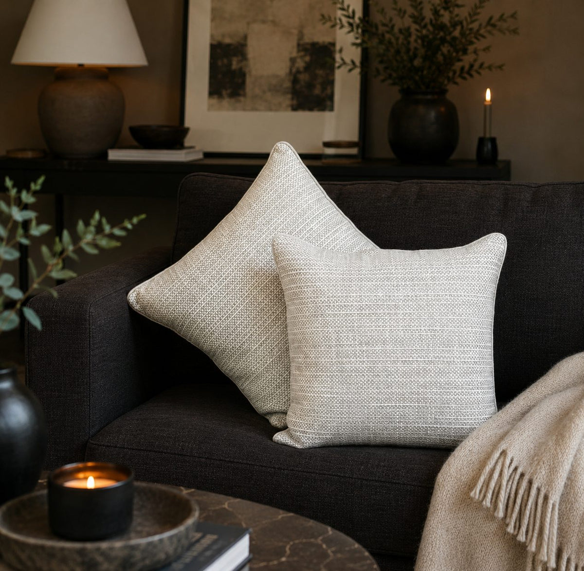 Premium beige striped linen cushion covers styled on a dark sofa in a modern living room, adding elegant texture and timeless luxury to contemporary home décor by Inara Home Decor.