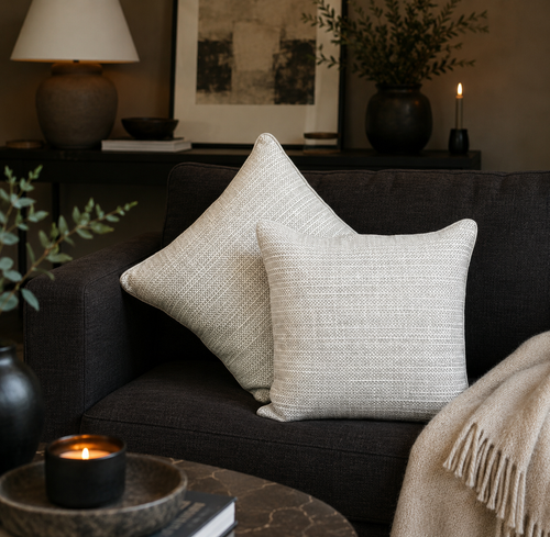 Premium beige striped linen cushion covers styled on a dark sofa in a modern living room, adding elegant texture and timeless luxury to contemporary home décor by Inara Home Decor.