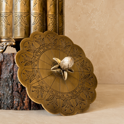Decorative antique brass storage box with engraved floral lid photographed in a premium luxury studio setting featuring a warm beige Venetian plaster wall and seamless matte microcement floor, ideal for elegant home décor and jewelry storage.