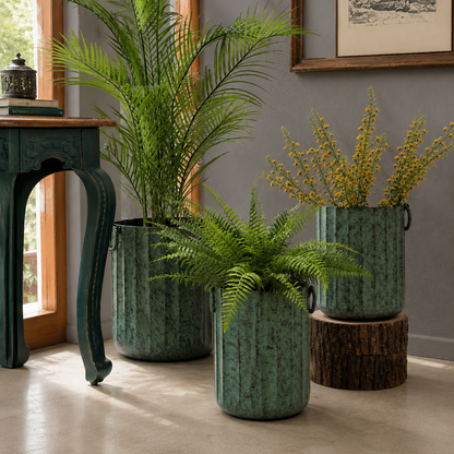 Distressed patina green indoor metal planters styled with Sansevieria snake plants in a luxury living room corner.