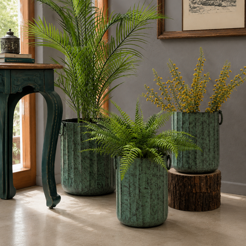 Distressed patina green indoor metal planters styled with Sansevieria snake plants in a luxury living room corner.