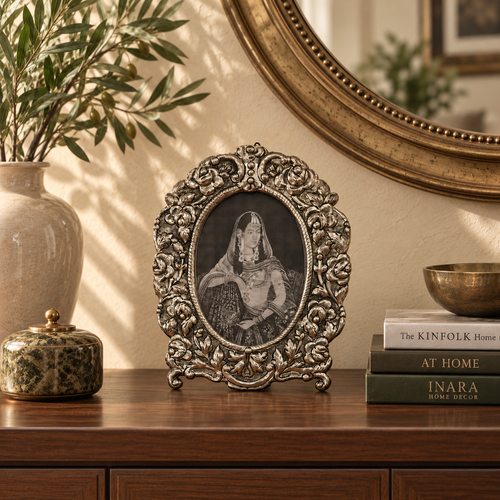 Florence Heirloom antique silver oval photo frame styled on a wooden console with decorative vase, books and mirror in a luxury living room.