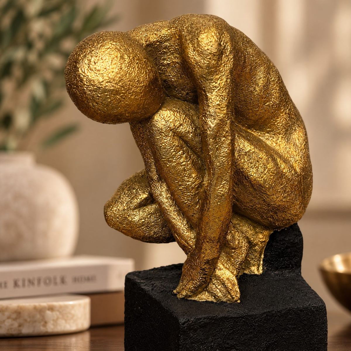 Close-up of luxury gold abstract human sculpture showcasing handcrafted textured finish and contemporary artistic design.