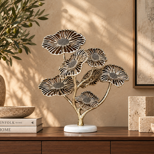 Elegant gold floral sculpture displayed on a walnut console table in a luxury contemporary living room with warm neutral décor.