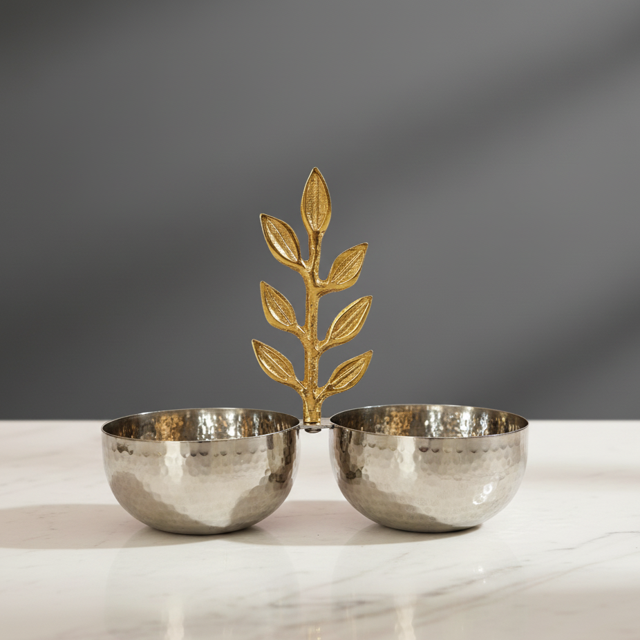 Elegant hammered stainless steel twin serving bowls with decorative gold leaf handle on a marble surface.
