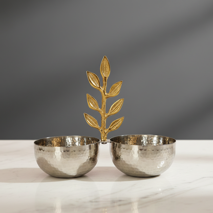 Elegant hammered stainless steel twin serving bowls with decorative gold leaf handle on a marble surface.